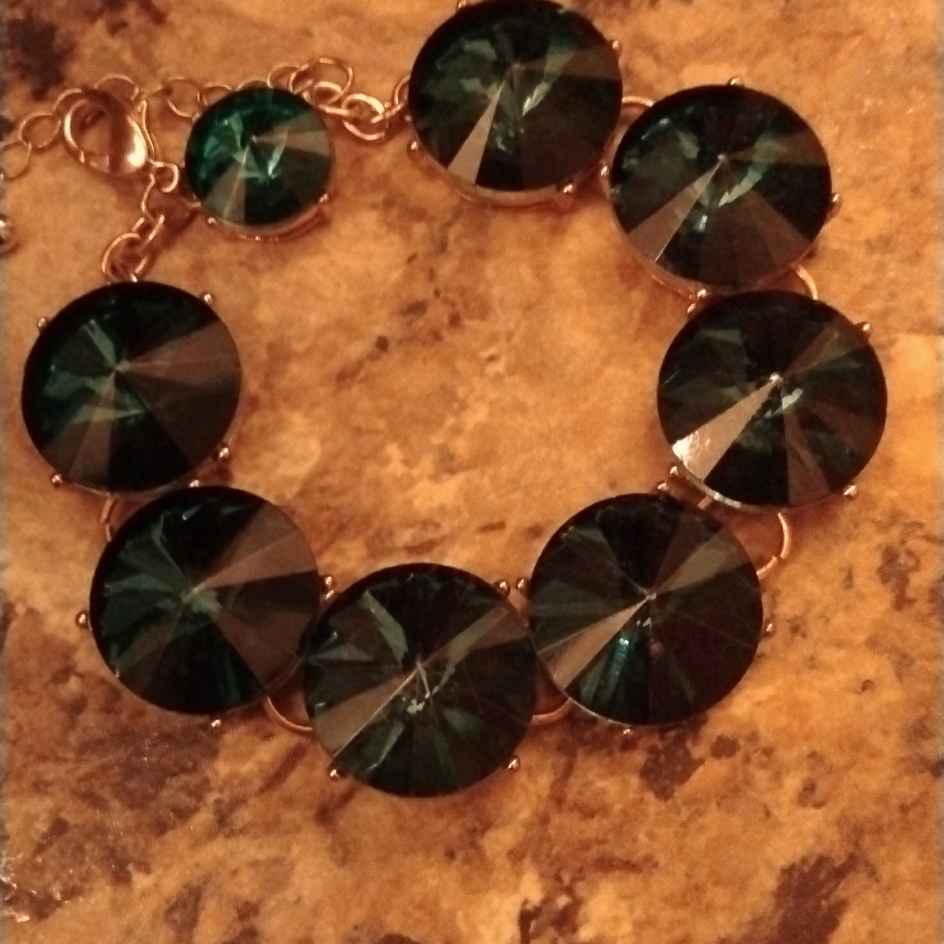 Bracelet Golden In Color With Beautiful Emerald Green Gems 30$